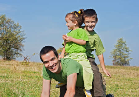 Father and his children playing outsideの写真素材