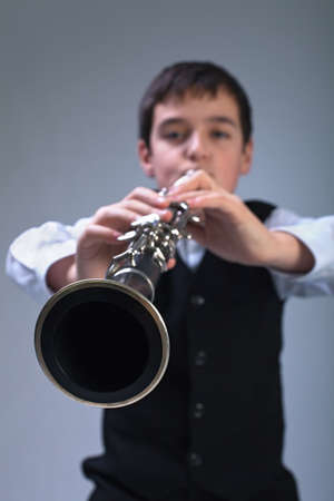 Little boy playing on the clarinetの写真素材