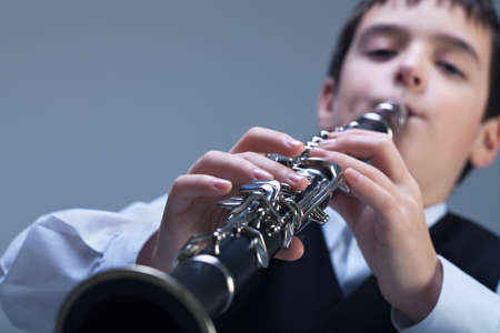 Little boy playing on the clarinetの写真素材