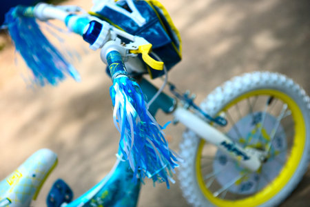 Blue child's bicycle is in  a town park .の写真素材