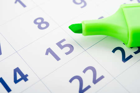 Green marker and open calendarの写真素材