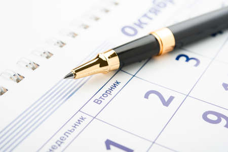 Setting a date. Calendar and pen.の写真素材