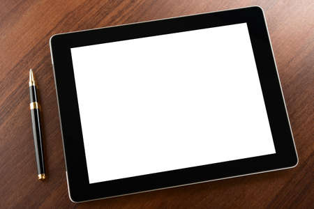 Tablet computer with blank screen on a businessman workplaceの写真素材