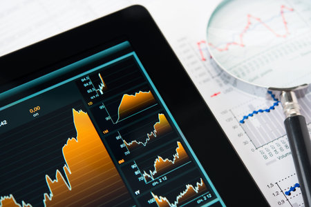 touching screen of tablet pc with market graph