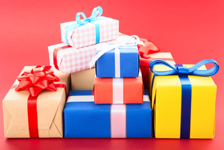 Gift boxes, isolated on red backgroundの写真素材
