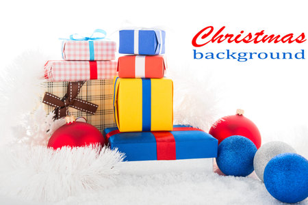 Gift box and Christmas tree decorations on a snow 