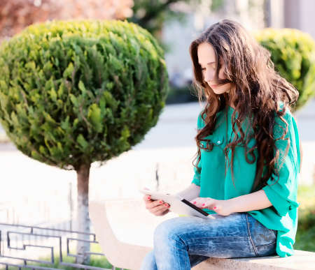 Young woman using tablet pc. Outdoor shootの写真素材