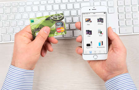SIMFEROPOL, RUSSIA - JANUARY 10, 2015: Apple Store application on Apple iPhone 6 display over Macbook keyboard. The Apple Store is the online store of Apple Inc.のeditorial素材