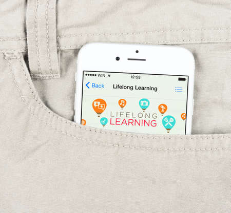 Simferopol, Russia - April 18, 2015: White Apple iPhone 6 in the pocket, displaying applications for lifelong learning in the Apple store.のeditorial素材