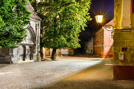 Night scene in Black Church Square, medieval downtown of Brasov, Transylvania in Romania.の写真素材