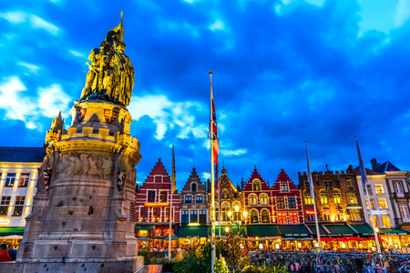 BRUGES, BELGIUM - 9 AUGUST 2014. Night image north side of Grote Markt (Markt) with enchanting street cafes, meeting place of the Brugelings and tourists. Brugge, Belgium.のeditorial素材