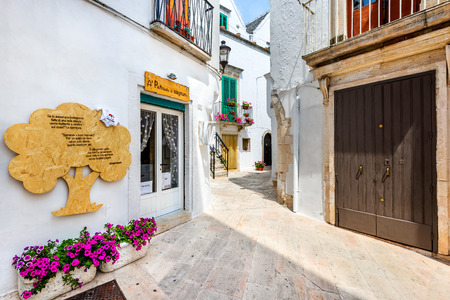 LOCORTONDO, ITALY - 10 JULY 2015: Medieval whitewashed street and houses in small city of Locorotondo, Puglia in Bari region.のeditorial素材