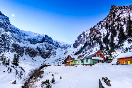 Carpathian Mountains, Romania. Winter twilight in Bucegi Mountains Natural Park, Malaiesti valley and touristic chalet.の写真素材