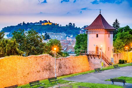 Brasov, Romania - Twilight image with medieval city walled fortifications, Black Church and the Citadel.のeditorial素材