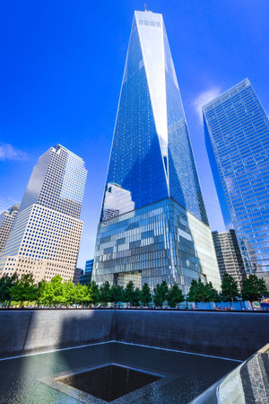 New York City, USA - Manhattan skyline with 9/11 Memorial and WTC tower (aka Freedom Tower)