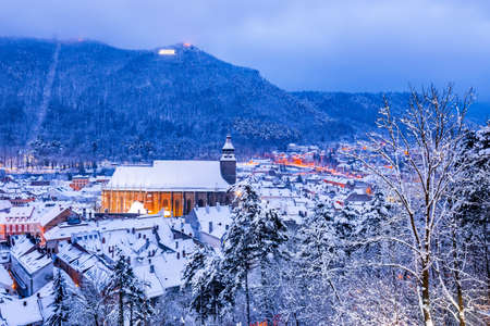 Brasov, Transylvania. Winter night scenery with Black Church and Carpathian Mountains, winter travel in Romania.のeditorial素材