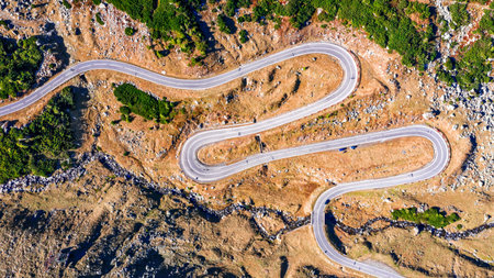 Winding road Transfagarasan through Carpathian Mountains at fall time. Aerial view by drone in...