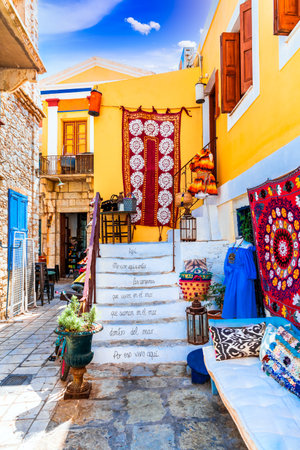 Symi Island, Greece. Greece islands holidays vacation travel tours from Rhodos island in Aegean Sea. Colorful neoclassical houses in bay of Symi.のeditorial素材