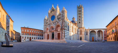 Siena, Italy. Beautiful view of facade and campanile of Siena Cathedral, Duomo di Siena at sunrise, Siena, Tuscany.の写真素材