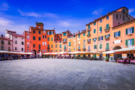 Lucca, Italy - Piazza dell'Anfiteatro is a historic amphitheater transformed into a charming square with cafes, shops, and lively atmosphere of Tuscany.の写真素材