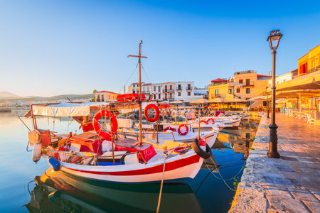 Rethymno, Greece. Beautiful city of Crete, Greek Islands, with Venetian Harbor and fishermen boats at sunrise.の写真素材