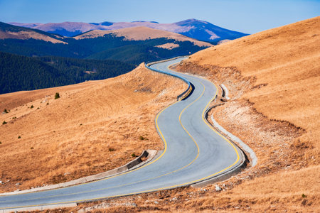 Transalpina, Romania. Highest altitude winding highway, crossing the Romanian Carpathian mountains at 2145 m altitude - October blue sky.の写真素材