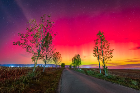 Northern lights or Aurora Borealis in night sky over Romania during a solar geomagnetic stormの写真素材