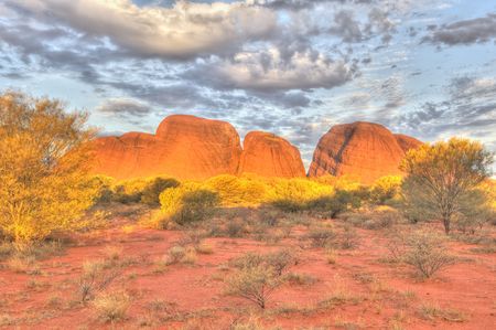The sun sets in the Simpson desert on Kata Tjuta (The Olgas), Australiaの写真素材