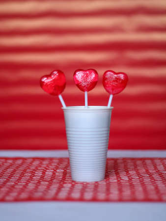 heart shaped lollipop in a plastic cupの写真素材