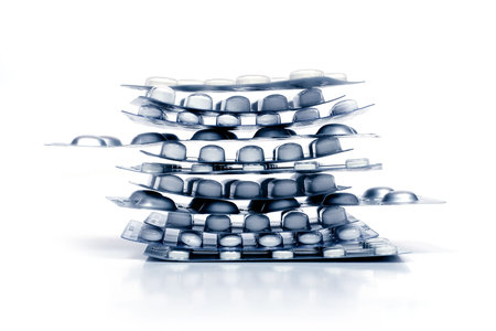 pile of pills in a blister isolated on white backgroundの写真素材