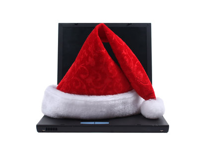 Santa hat on laptop isolated on white backgroundの写真素材