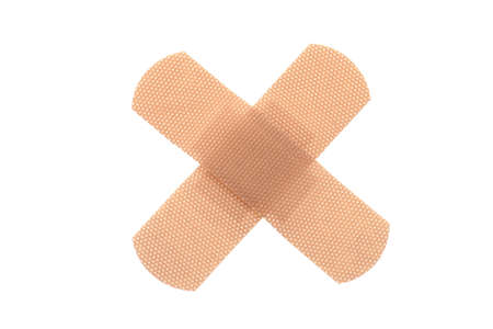Bandaid in cross shape, isolated white backgroundの写真素材
