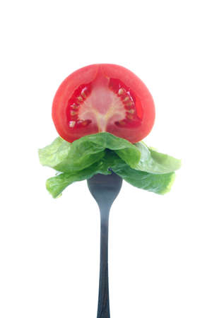 tomato slice and salad on forkの写真素材