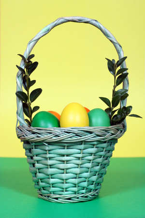 colorful easter eggs in a basketの写真素材