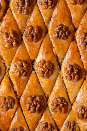 Pattern Turkish baklava with walnuts in honey glaze. Oriental sweet pastry top view.