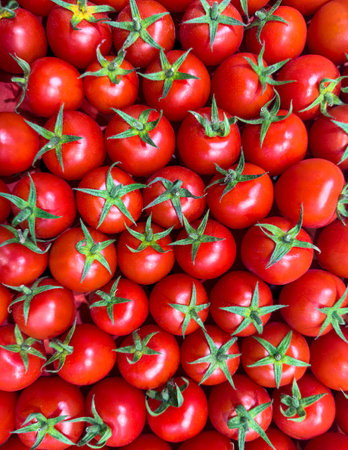 Pattern of red small cherry tomatoes. Top view of fresh organic vegetables, close-up. Natural products grown in the garden.の写真素材