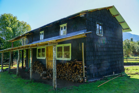 rustic wooden house in the country side with the sun comingの写真素材