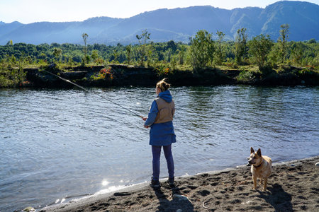 Image of a woman fishing in a river in the south of Chileの写真素材