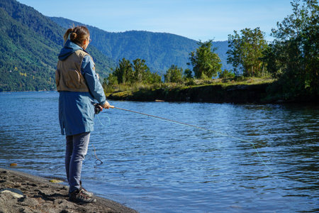 Image of a woman fishing in a river in the south of Chileの写真素材