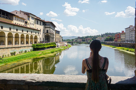 A woman admiring the view of the Ponte Vecchio in Florenceの写真素材
