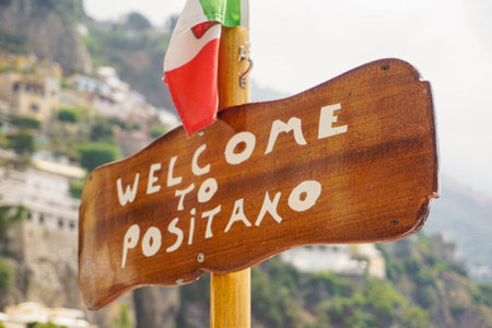Iconic wooden sign with an Italian flag that says: "Welcome to Positano"の写真素材