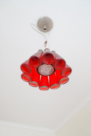 Creative lamp made out of recycled red glass bottlesの写真素材
