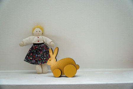 Cute little girl and a wooden rabbitの写真素材