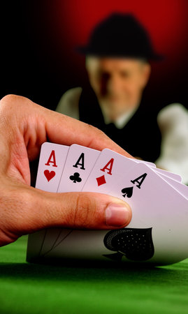 Four aces in a poker game, man in the background
