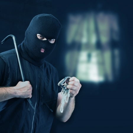 Masked thief stealing jewelry の写真素材