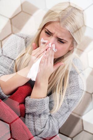 Sick woman blowing her noseの写真素材