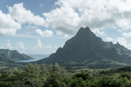 A mountain on the island of Moorea in front of its lagoonsの写真素材