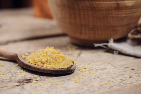 Raw Bulgur on wooden backgroundの写真素材