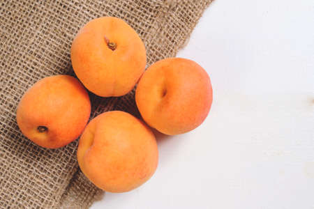 Fresh apricots on wooden tableの写真素材