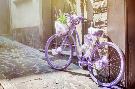 Purple bike with lavender bouquet in basketの写真素材